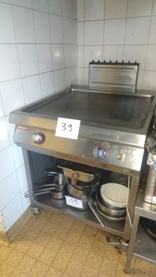 a stainless steel counter with pots and pans on it