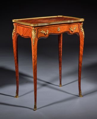 a small table with a wooden top and gold trimming