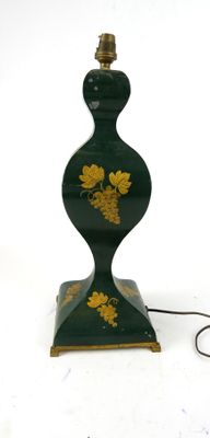 a green lamp that has a gold leaf design on it