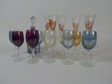 many different colored wine glasses sitting next to each other
