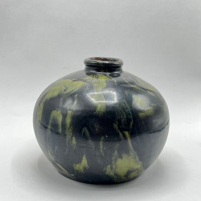 an image of a black and green vase on a white background