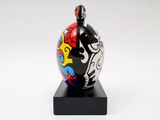 sculpture of a black and white vase with a red, yellow, blue, and black design