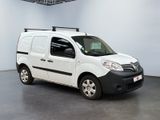 a white van parked in a room with a black roof rack