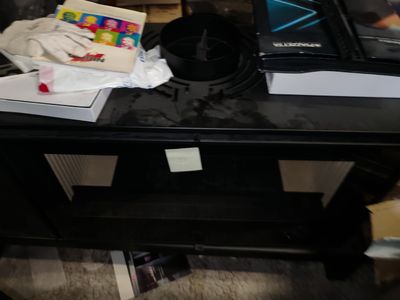 a black coffee table with a laptop on top of it