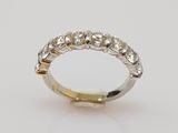 a white and yellow gold wedding ring with diamonds