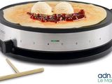 an image of a crepe maker with two scoops of ice cream on top