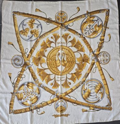 an image of a square scarf with gold and white designs