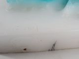 a blue and white soap that is sitting on a counter