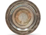 an image of a silver plate with a circular design on it