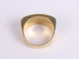 an image of a gold ring on a white surface