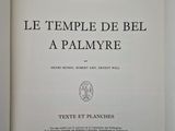 an open book on a white surface with a black and white title