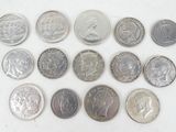 a lot of coins that are on a white surface