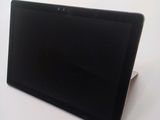 a black tablet computer sitting on a white surface