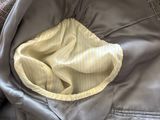 a jacket with a blanket inside of it sitting on a bed