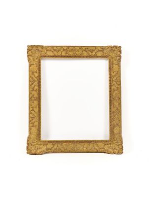 a gold picture frame on a white wall with a white background