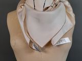 a close up of a mannequin torso with a white scarf on it