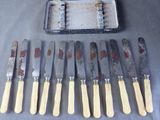 a lot of knives that are sitting on a table