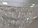 a glass vase with a flower inside of it on a table