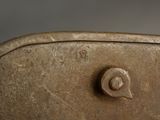 a close up of a piece of metal with a button