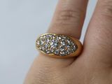 someone is holding a gold ring with three diamonds on it