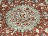 a red and blue rug with a medallion design on it