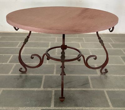 a small table with a red top on a brick floor