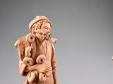a statue of a man sitting on a chair with a dog