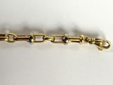 an image of a close up of a gold plated bracelet