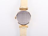 an image of a close up of a wrist watch on a white surface
