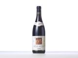 a bottle of wine sitting on top of a white table