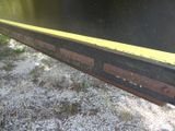 a yellow line on the side of a train track