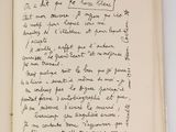 an open book with a handwritten poem on it sitting on a table