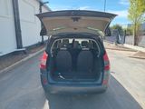a small car with its trunk open on the street