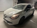 the white car is parked in a parking garage with its lights on
