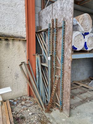 a pile of wood sitting in the corner of a building