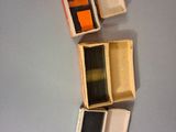 four boxes of different colors and sizes on a table