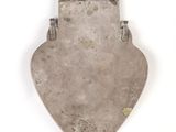 an antique silver plate with a metal handle on a white background