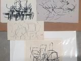 trois dessins sur une feuille de papier posée sur une table