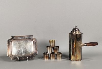 a silver tea pot and a silver tea set on a table