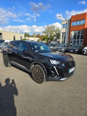 the black suv is parked in a parking lot with other cars