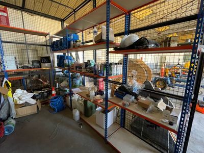 many shelves with various items in them in a warehouse