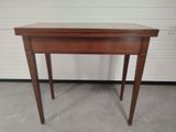 a small wooden table with a drawer on it