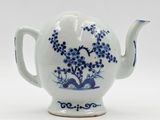 blue and white teapot with flowers and birds on it