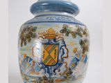 a blue and white vase with a coat of arms on it