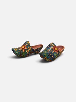a pair of wooden clogs with floral designs on them