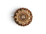 an image of a gold broochle on a white background