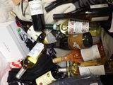 many bottles of wine in a plastic bag on the floor