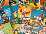 several mickey mouse books are stacked on top of each other