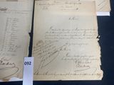 three old papers with handwriting on them are on a table