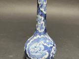 a blue and white vase with a dragon design on it